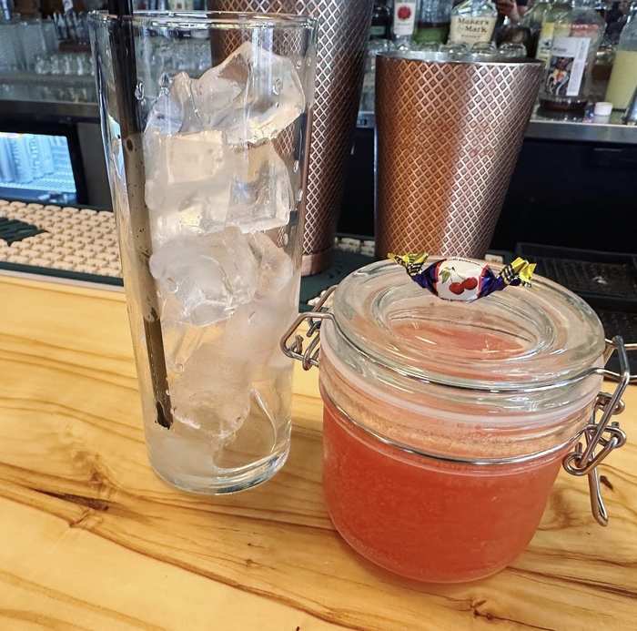 House cocktail with Polish cherry candy garnish at the bar