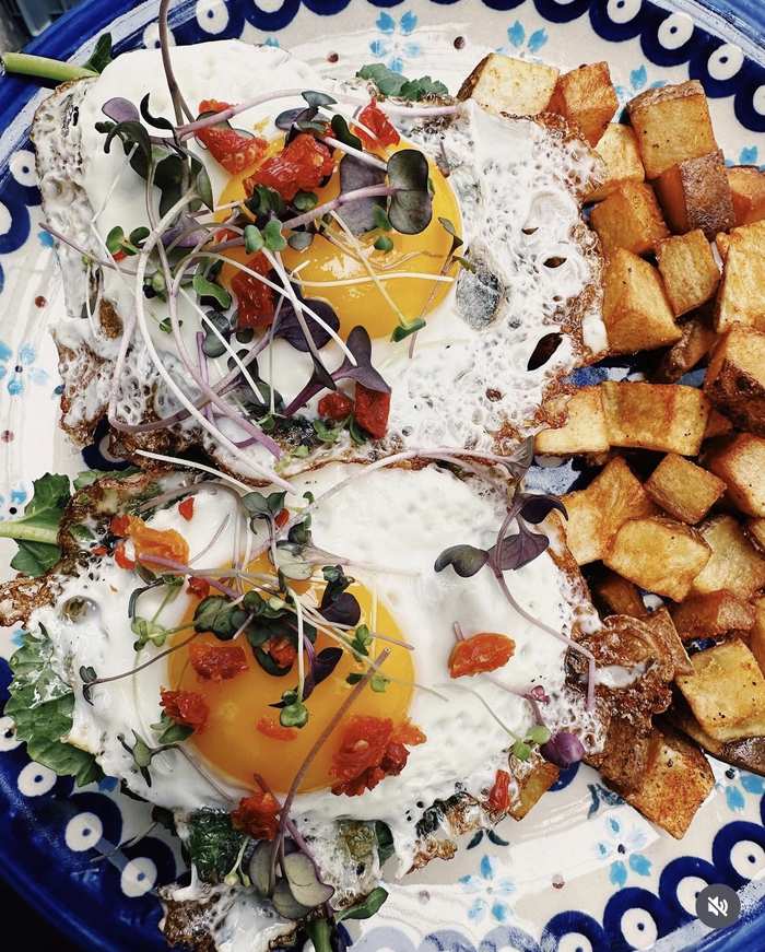 Sunny eggs with breakfast potatoes and microgreens