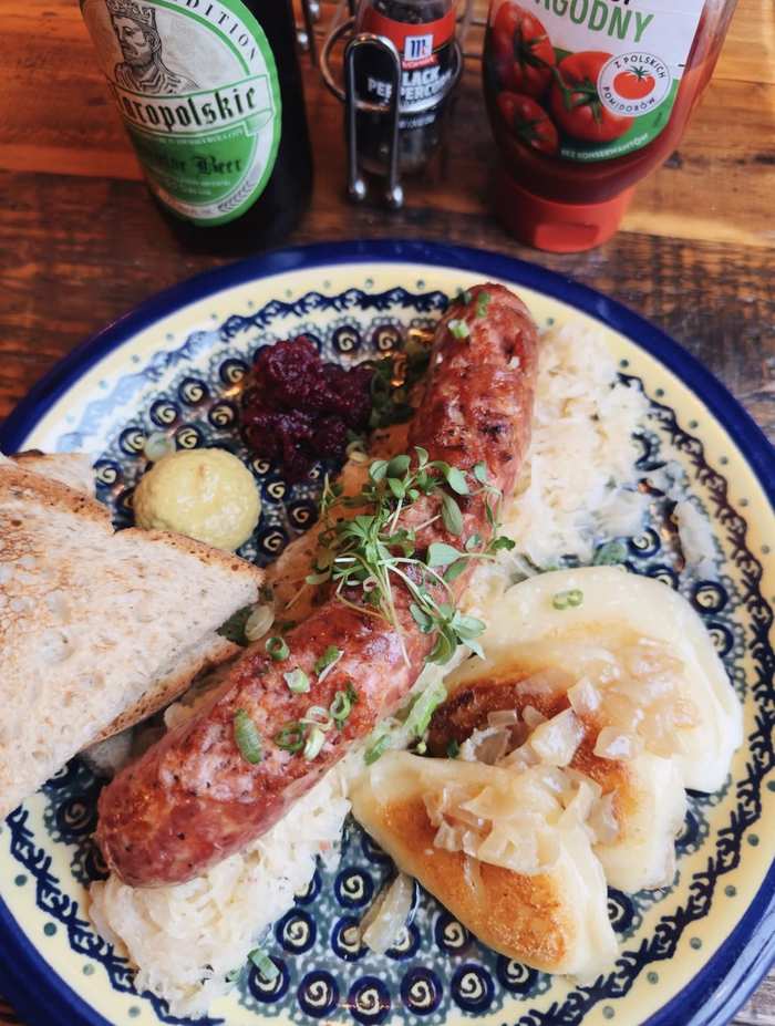 Grilled kielbasa with pierogi, kraut and Polish beer