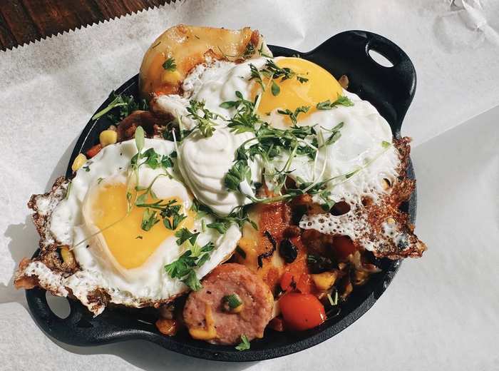 Brunch skillet with sunny eggs, kielbasa and pierogi