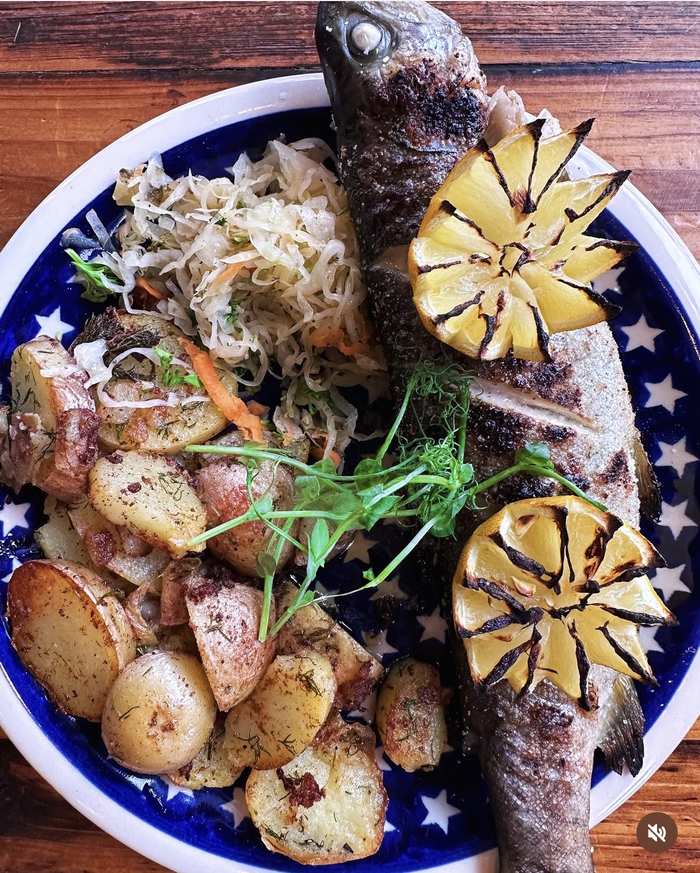 Whole trout with charred lemon, potatoes and kraut slaw